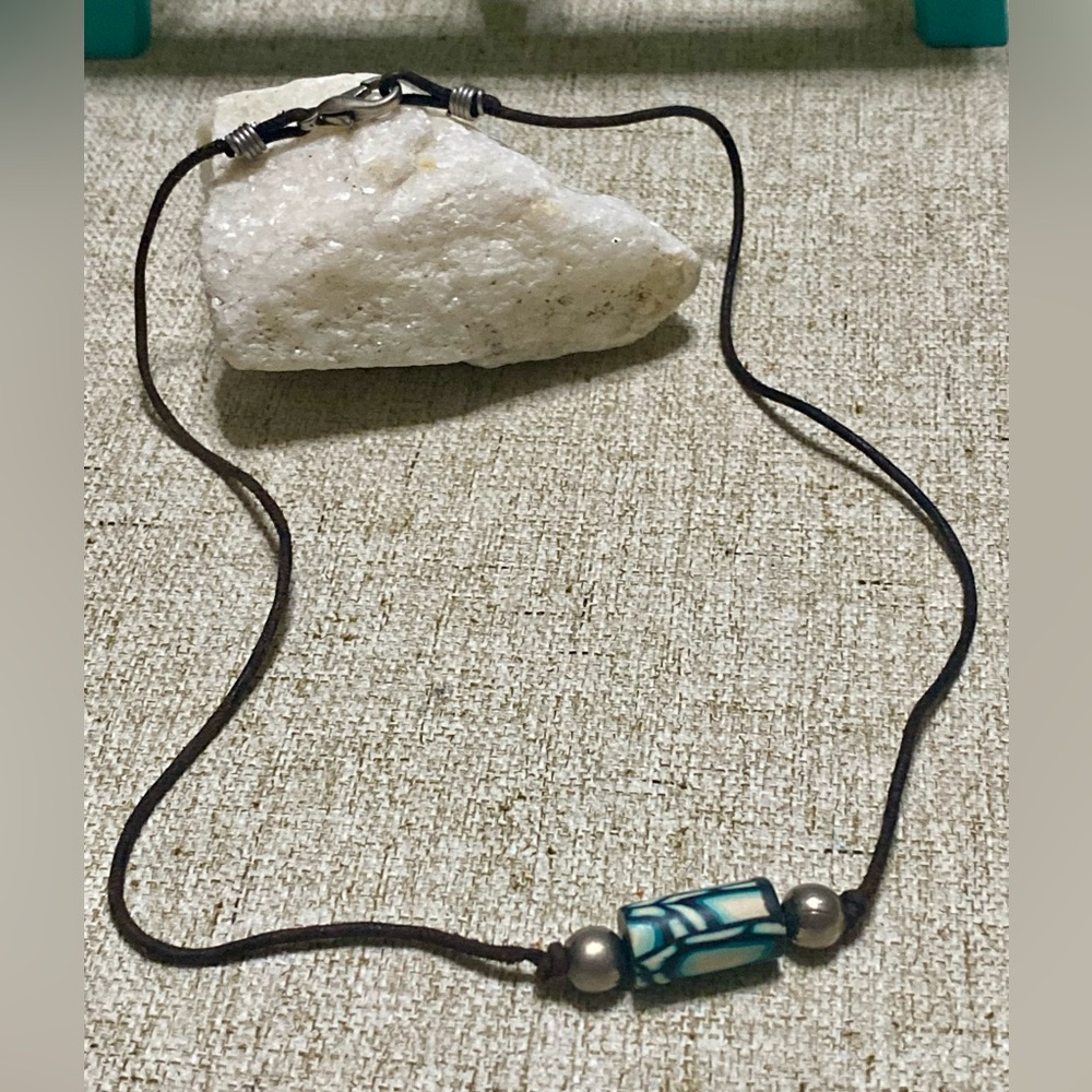 Leather strap necklace .Native pendant, in the center .. with beads on the sides